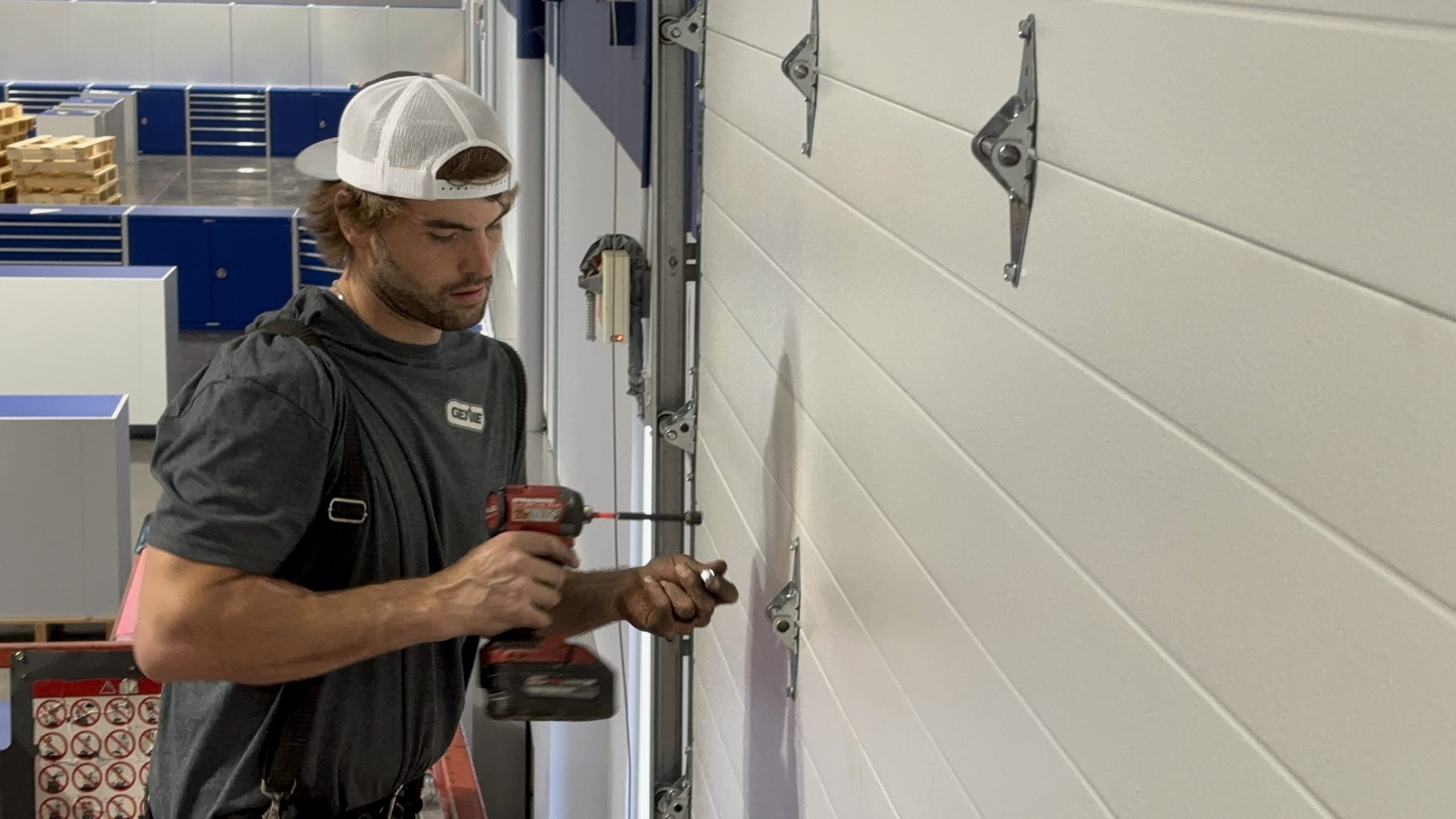 Stapley Action Garage Door technician repairing a garage door in Mesa, AZ